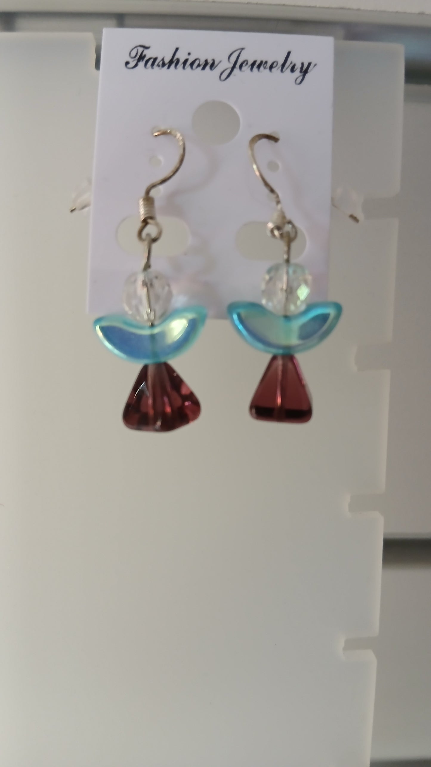 . These earrings feature a beautiful combination of crystal and glass elements, carefully crafted to create a celestial look. The sterling silver earwires add a touch of elegance, making them a perfect gift for yourself or a loved one.