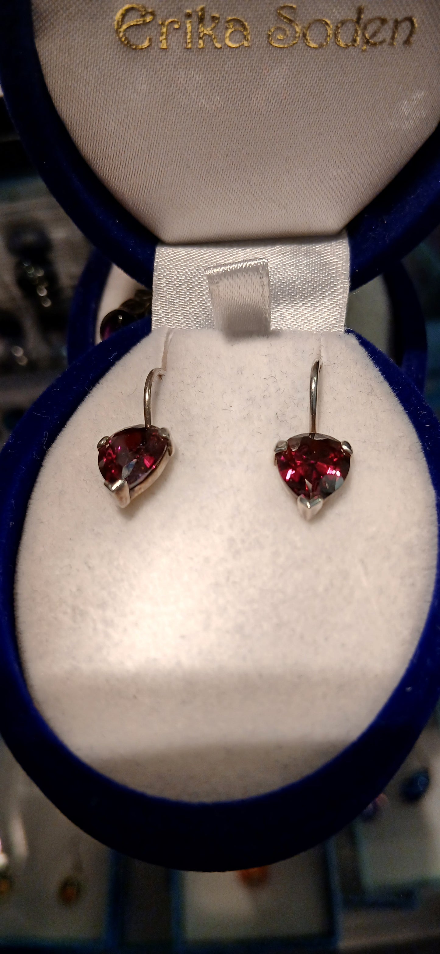 The garnet-coloured cubic zirconia stones offer exceptional brilliance and clarity, capturing and reflecting light beautifully to create stunning sparkle that rivals genuine gemstones. The deep red colour creates a striking contrast against the bright sterling silver setting, enhancing both the stone's fiery beauty and the metal's lustrous finish.