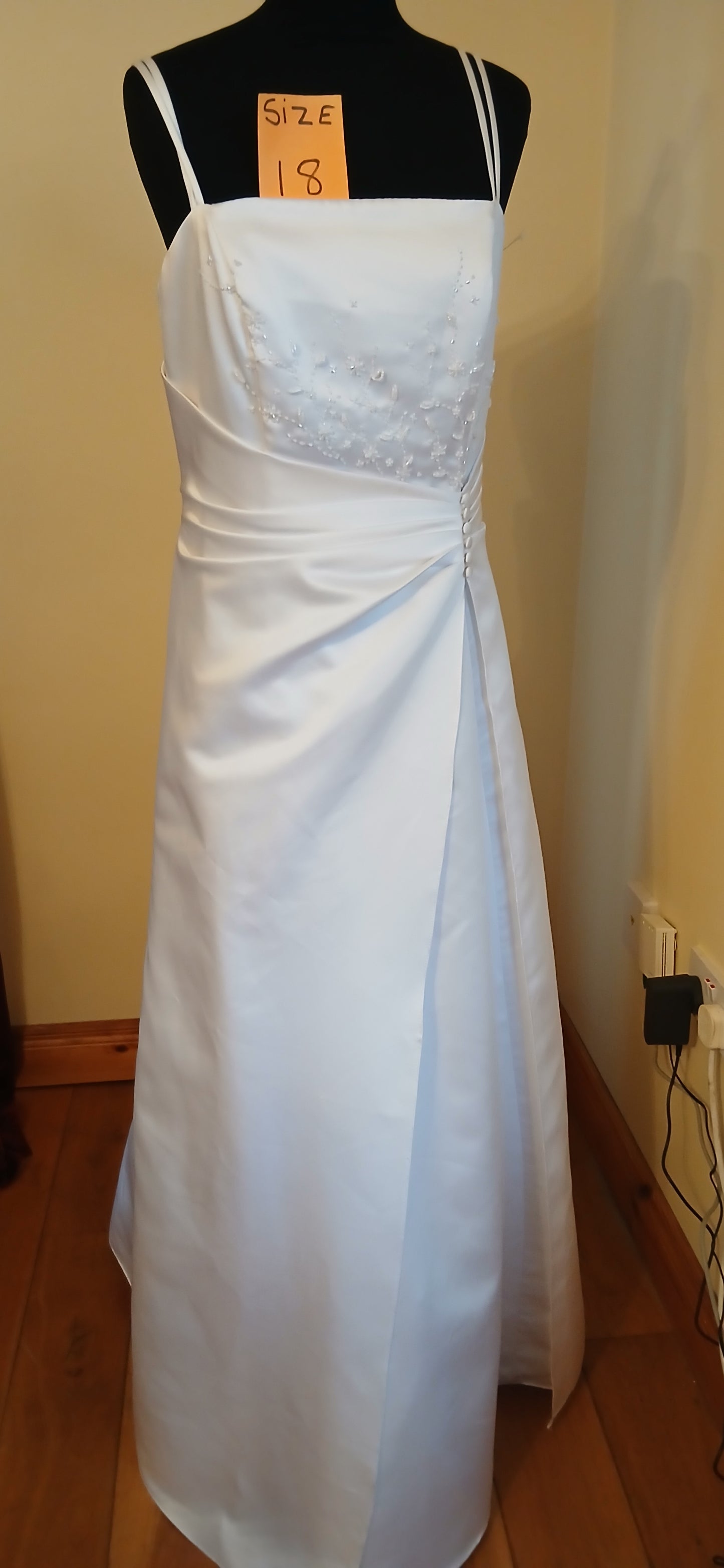 white wedding dress is a perfect fit for a size 18. It's a clearance stock item, offering a fantastic opportunity to own a beautiful wedding dress at a discounted price.