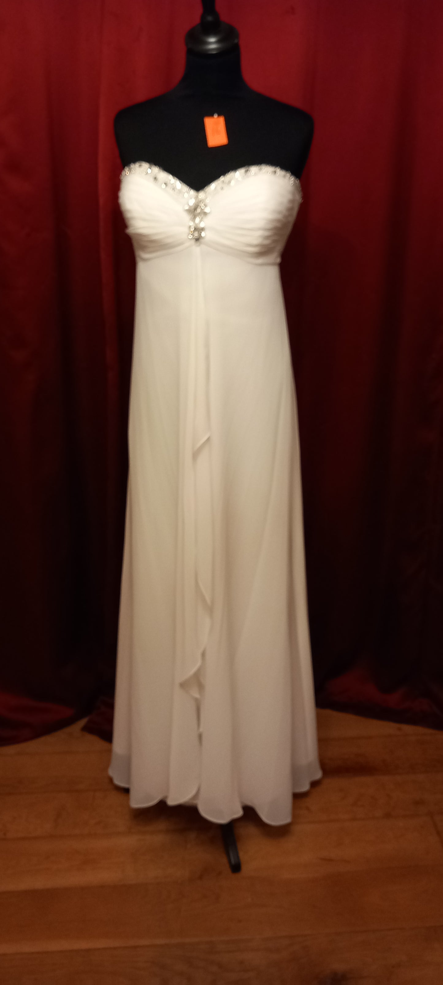  featuring a beautiful empire line design with a stunning beaded sweetheart neckline.