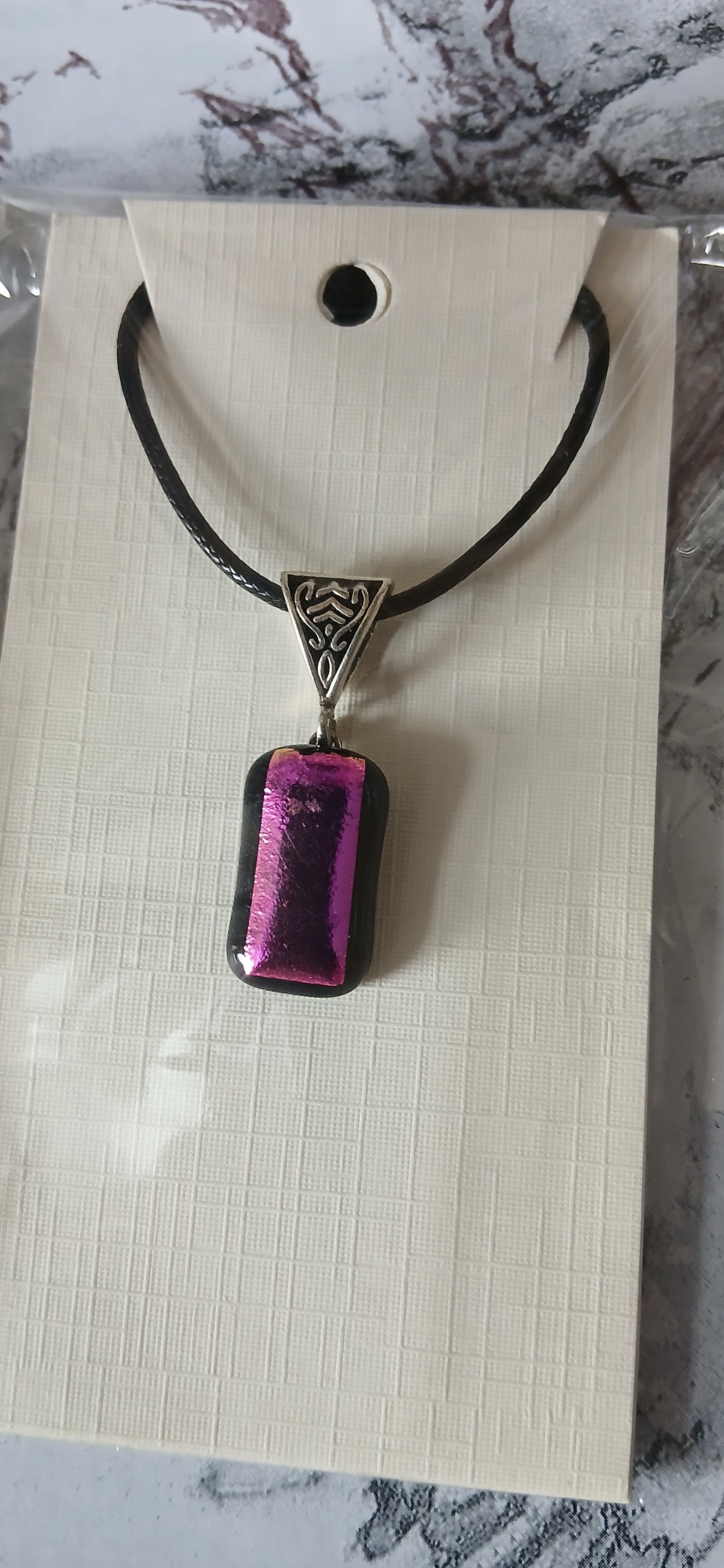 mesmerizing pink and black dichroic pendant on cord or can be put on your own chain