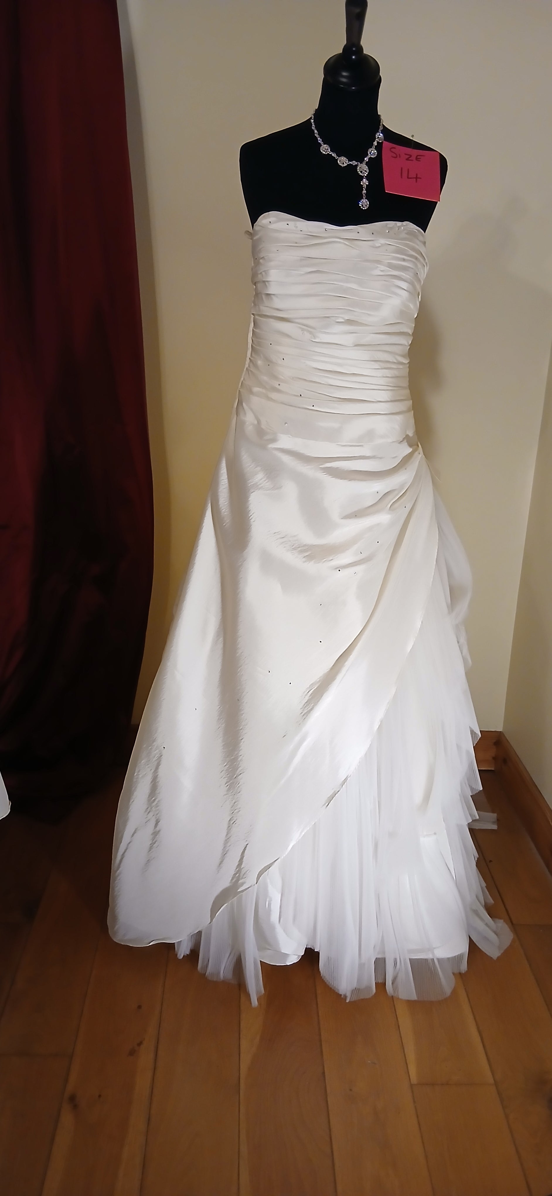 Experience the magic of our Taffeta and Tulle Wedding Dress Venus. This size 14 ivory dress is a clearance sale item, offering you a chance to own a piece of elegance at a fraction of the cost. The taffeta and tulle fabrics come together to create a mesmerizing visual effect, making it a perfect choice for your special day.