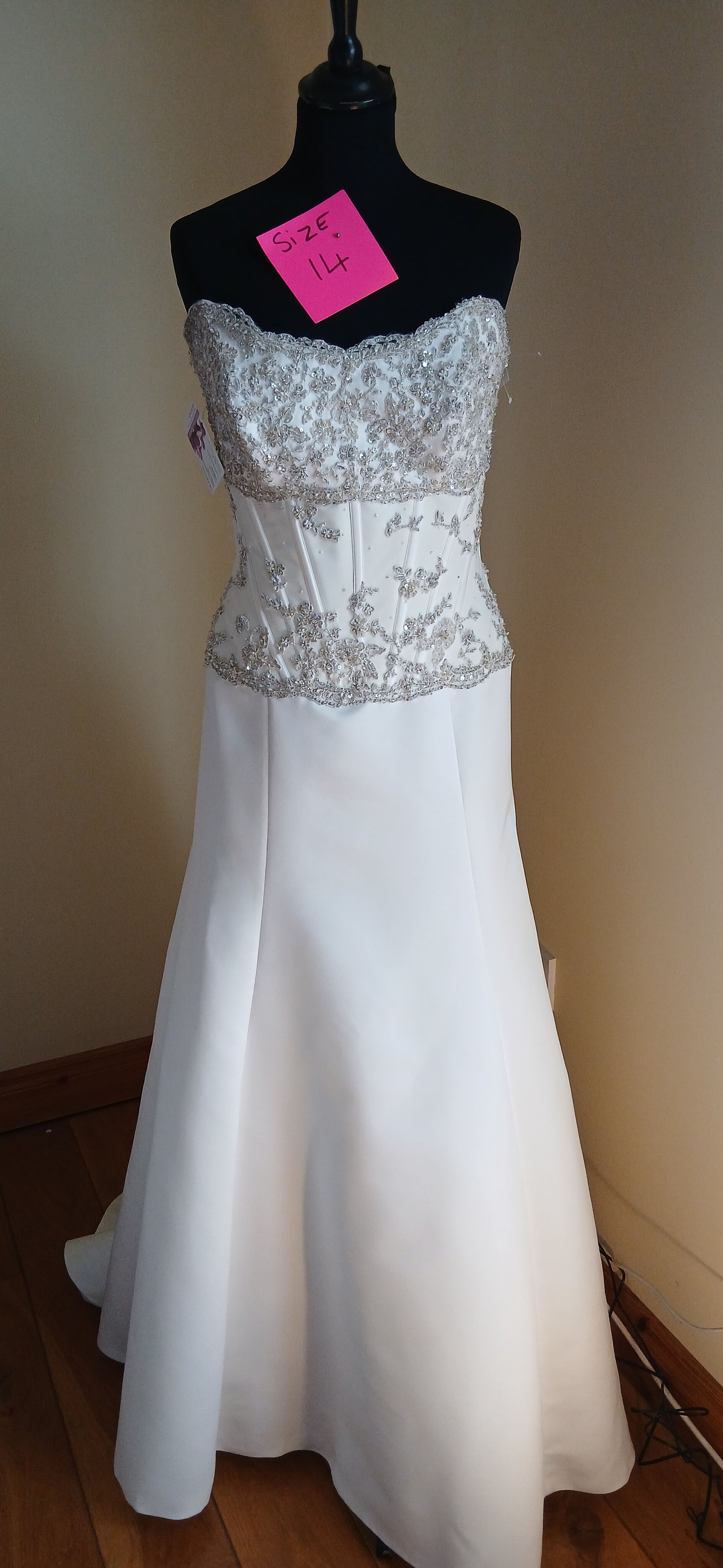It features a beautifully crafted bodice with beaded lace and a boned corset for a flattering silhouette