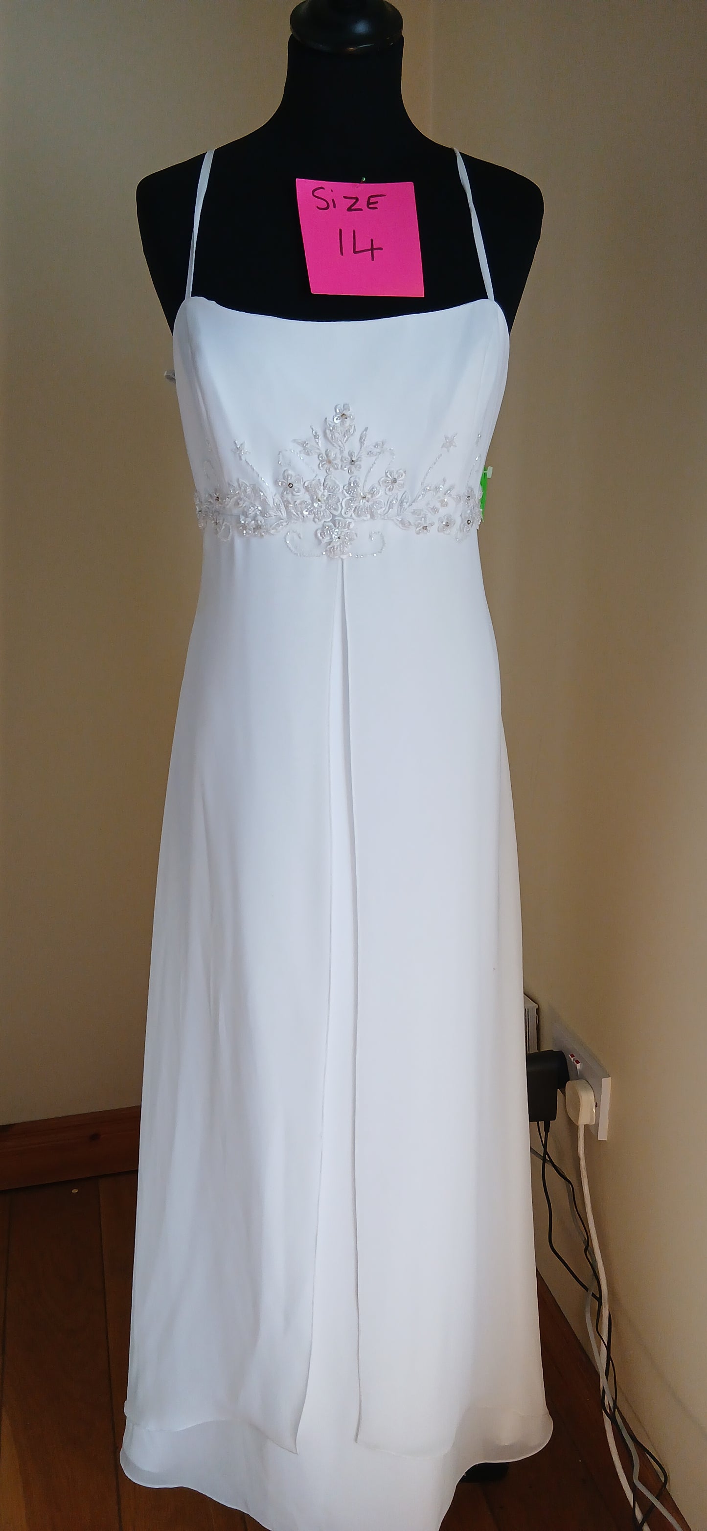 This exquisite wedding dress is a size 14 and is a perfect blend of elegance and comfort. 