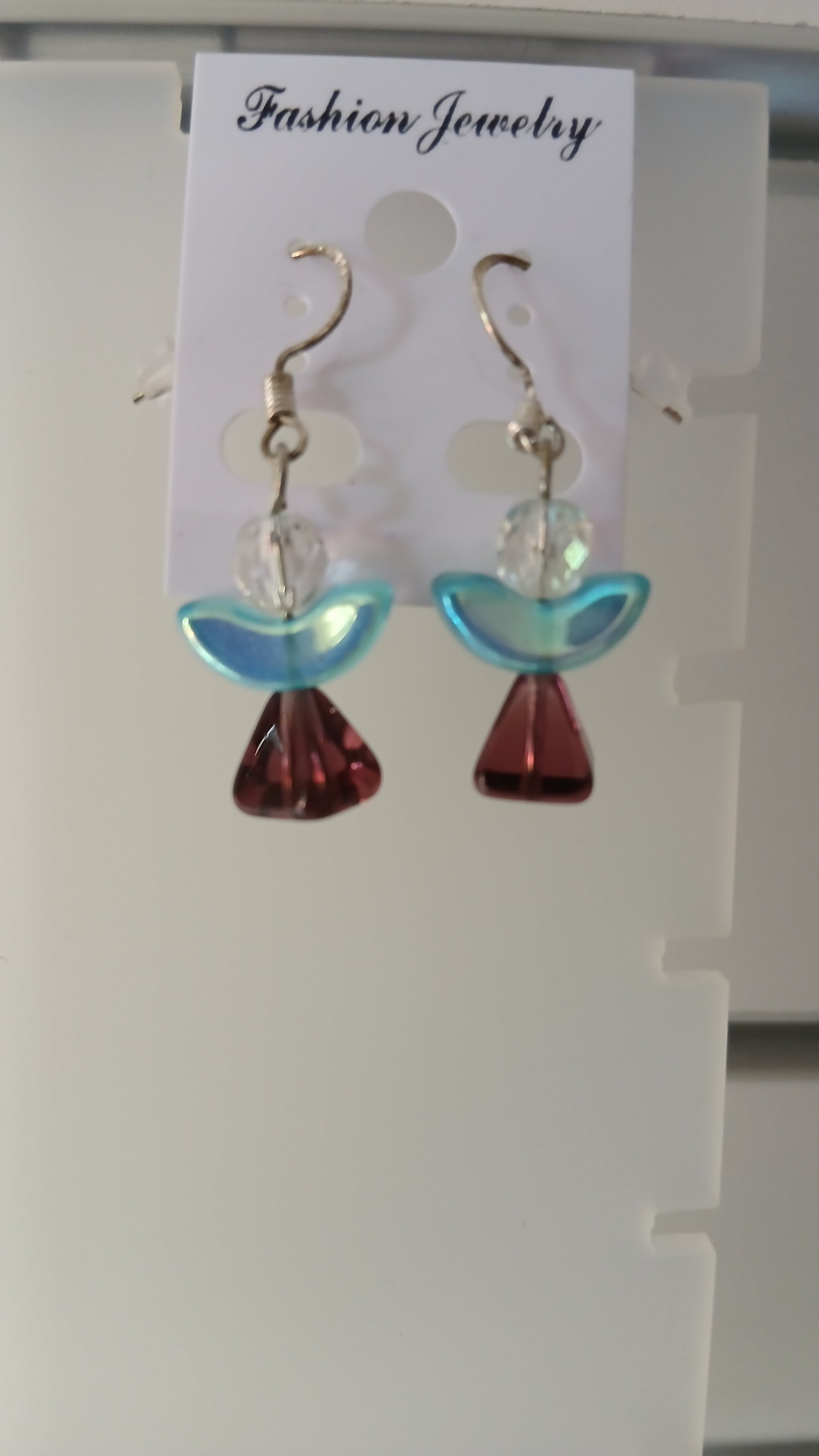 . These earrings feature a beautiful combination of crystal and glass elements, carefully crafted to create a celestial look. The sterling silver earwires add a touch of elegance, making them a perfect gift for yourself or a loved one. 