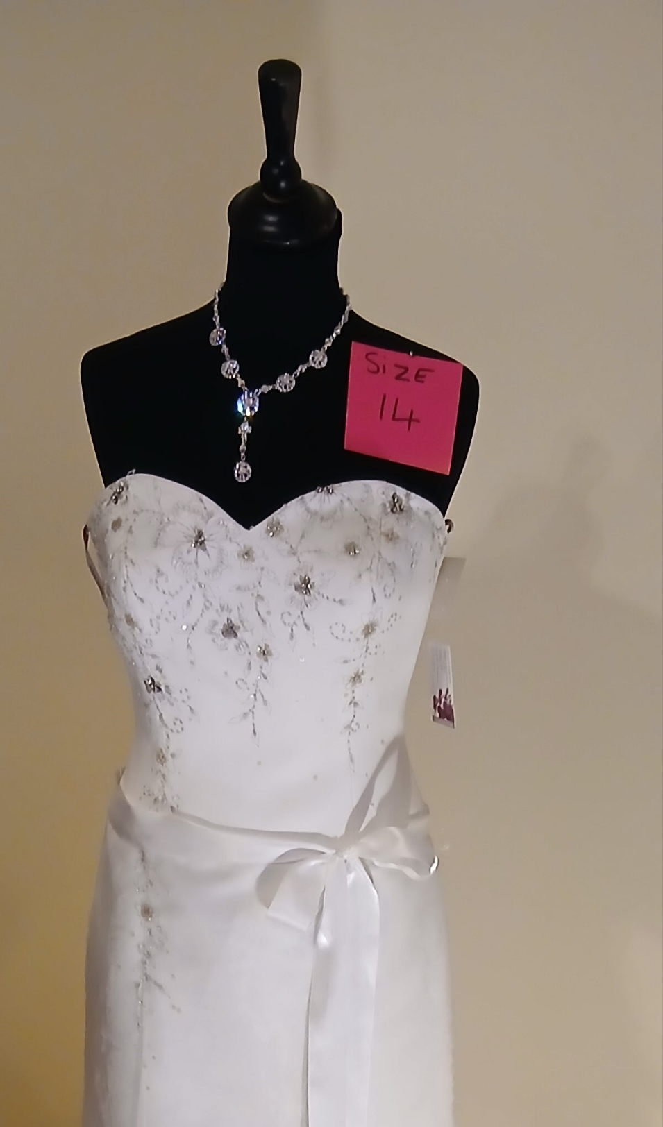 beautiful sweet heart neckline delicate beading over bodice , satin belt 