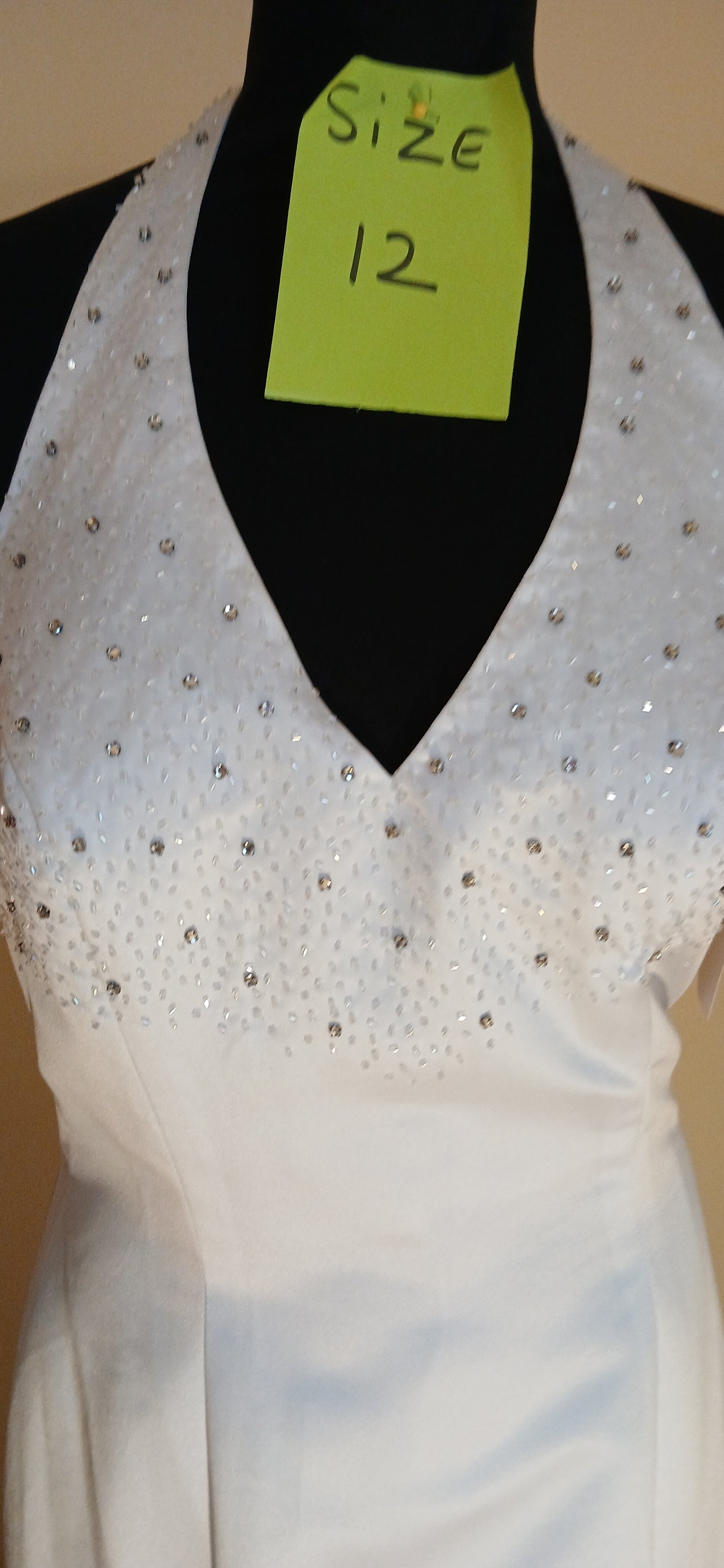 It features beautiful beaded diamond details down the train, adding a touch of elegance and sophistication to your special day.