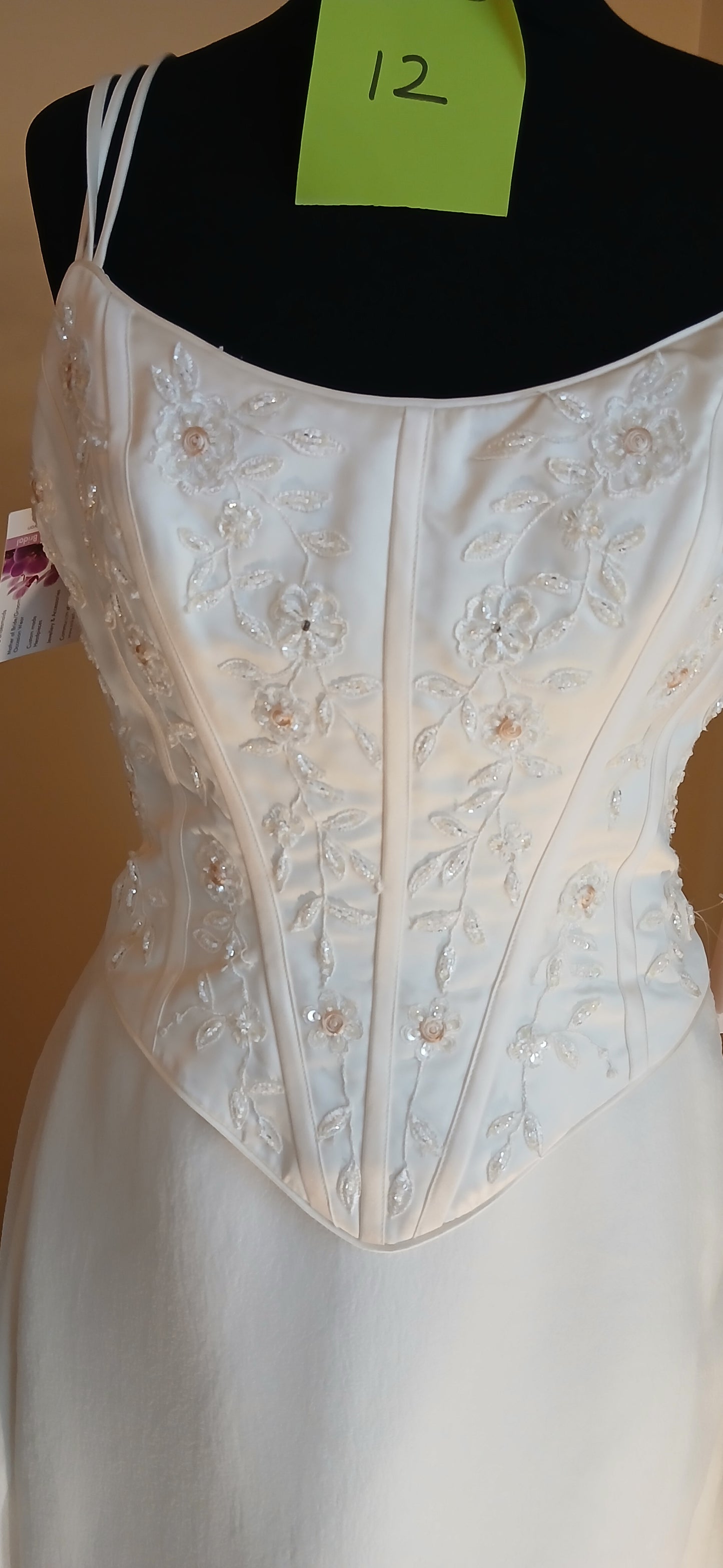 This exquisite wedding dress is a size 12 in elegant ivory. It features a detachable train,