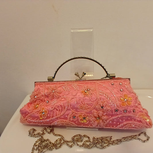 Pink beaded  handbag with added silver shoulders strap