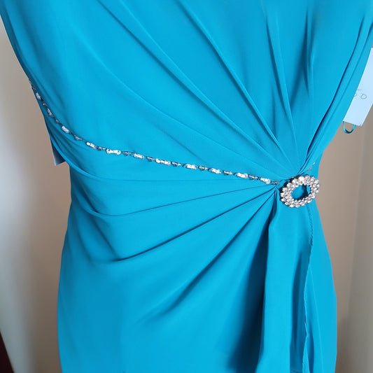 Close-up of a blue dress with a decorative embellishments.
