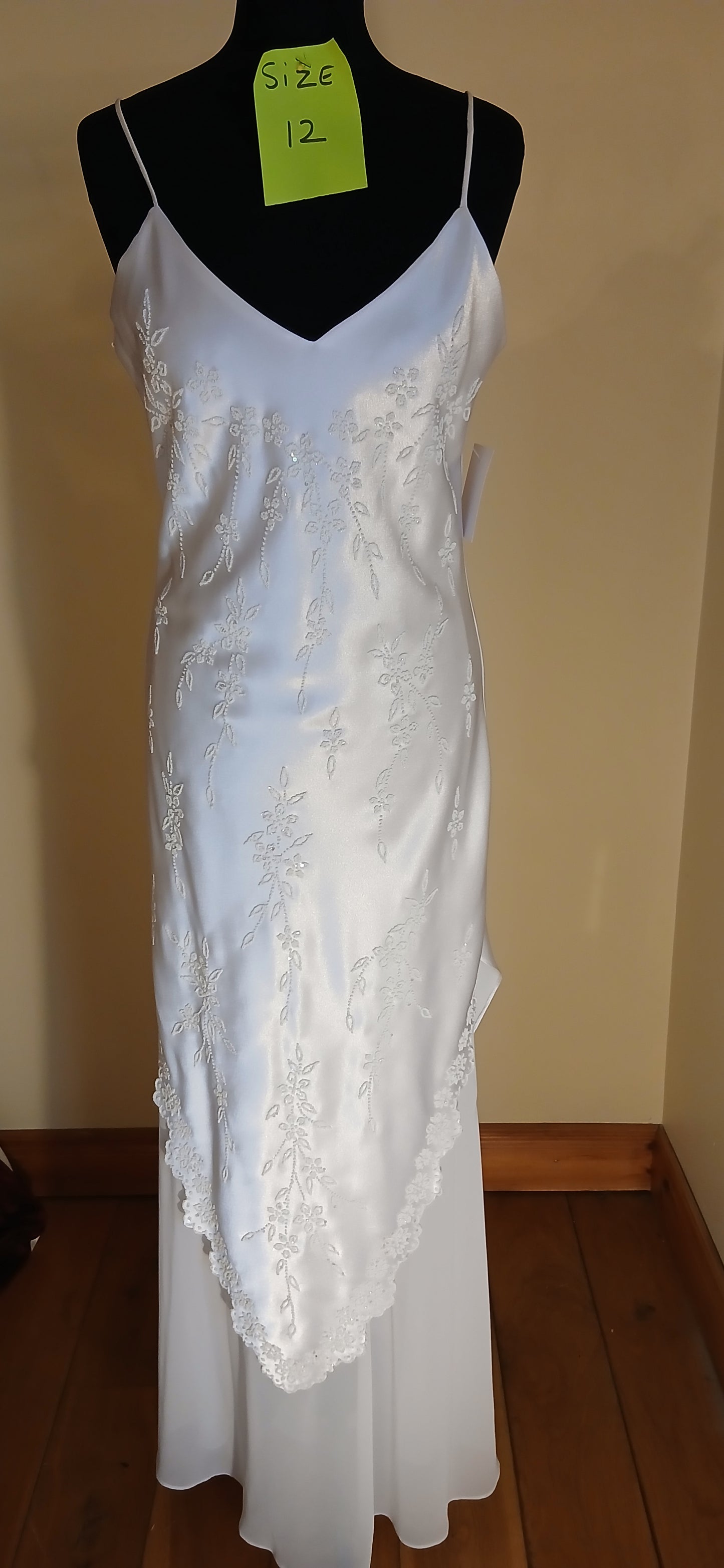 Wedding dress Annabell, a size 12 white Chiffon with satin overlay, featuring delicate  straps. This exquisite dress is in our clearance sale