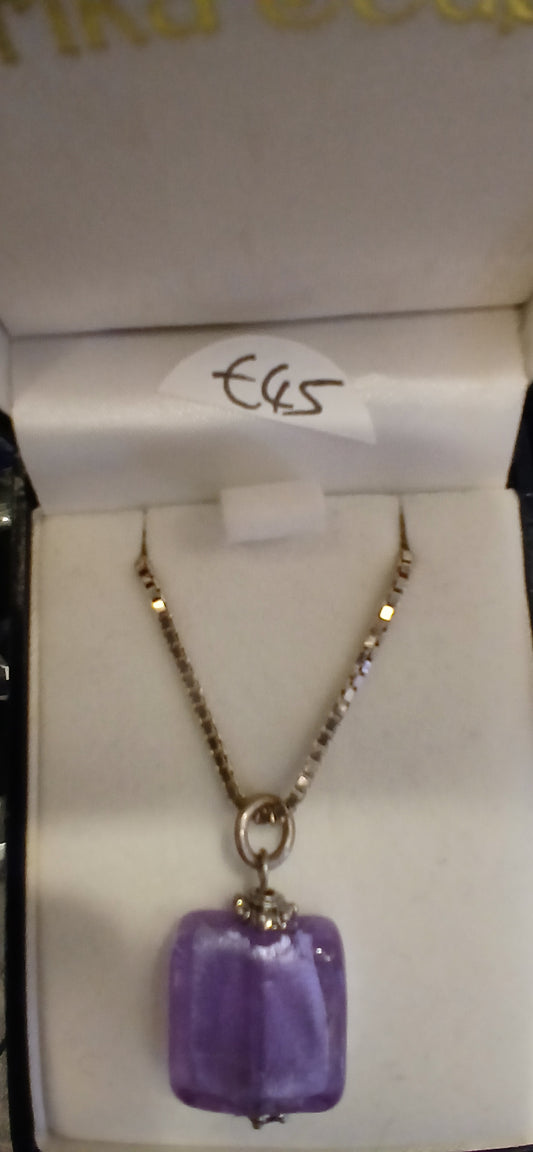 Experience the elegance and sophistication of our Purple and Sterling Silver Necklace and Earrings Set. This set features a beautiful purple necklace with a sterling silver chain, complemented by a pair of earrings with sterling silver earwires. Perfect for those who appreciate the finer things in life.