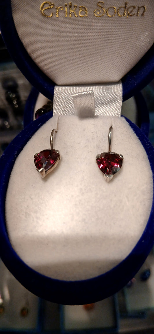 The garnet-coloured cubic zirconia stones offer exceptional brilliance and clarity, capturing and reflecting light beautifully to create stunning sparkle that rivals genuine gemstones. The deep red colour creates a striking contrast against the bright sterling silver setting, enhancing both the stone's fiery beauty and the metal's lustrous finish.