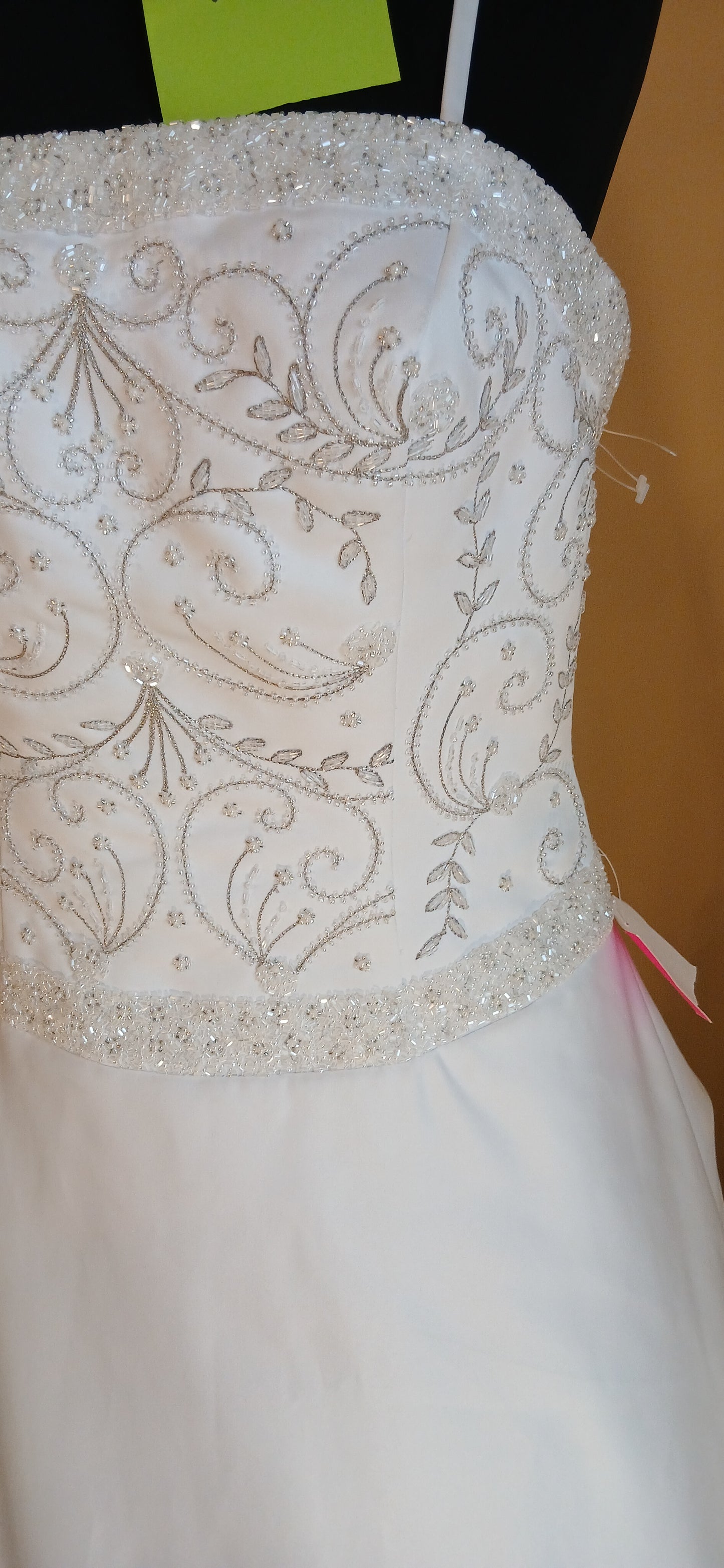  features a beautifully beaded bodice that adds a touch of elegance to your special day.