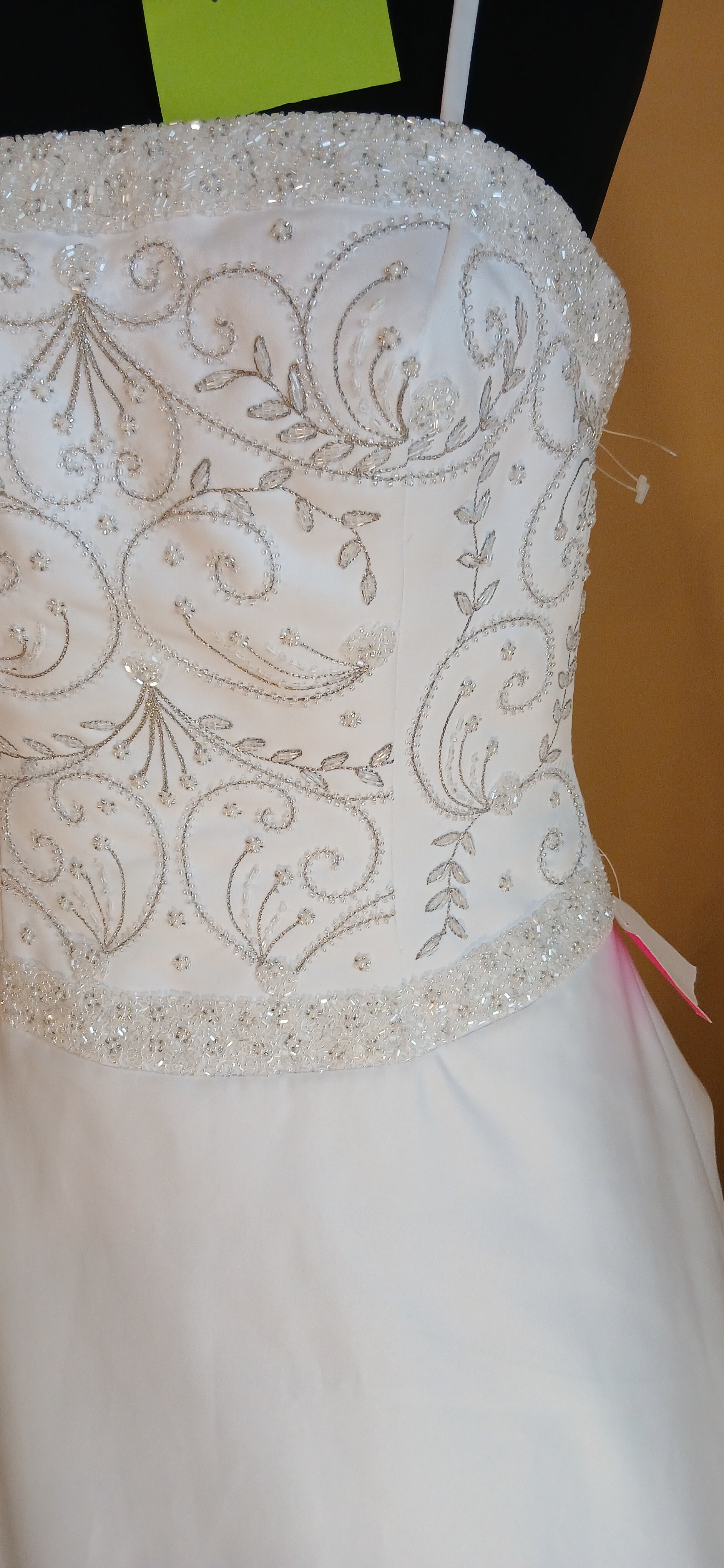  features a beautifully beaded bodice that adds a touch of elegance to your special day.