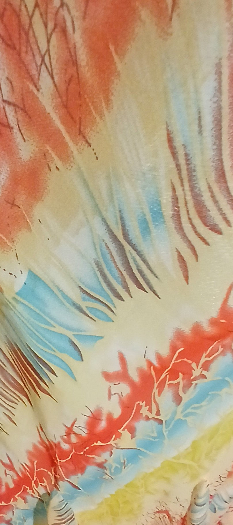 Colorful tie-dye pattern with red, orange, yellow, and blue hues.