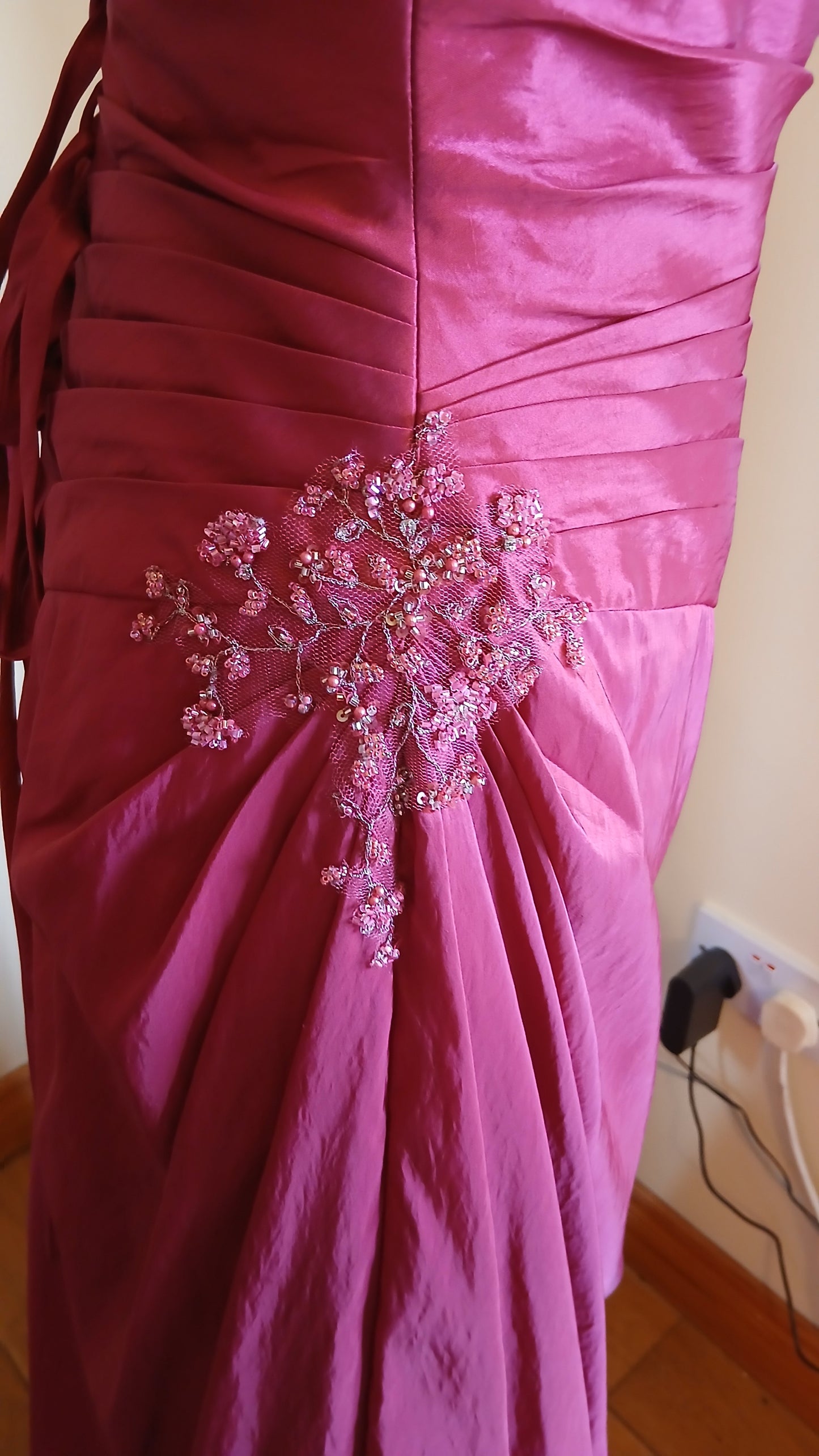 "Beautiful embellishments on cerise dress"