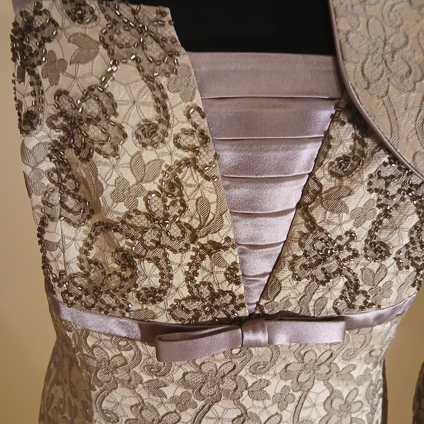  stunning size 16 Mother of the Bride and Groom outfit, expertly crafted by Veromia. This exquisite ensemble features a delicate lace dress with wide ribbon straps and a matching bolero jacket with 3/4 length sleeves. The intricate details and flawless design make it the perfect choice for such a special occasion. 