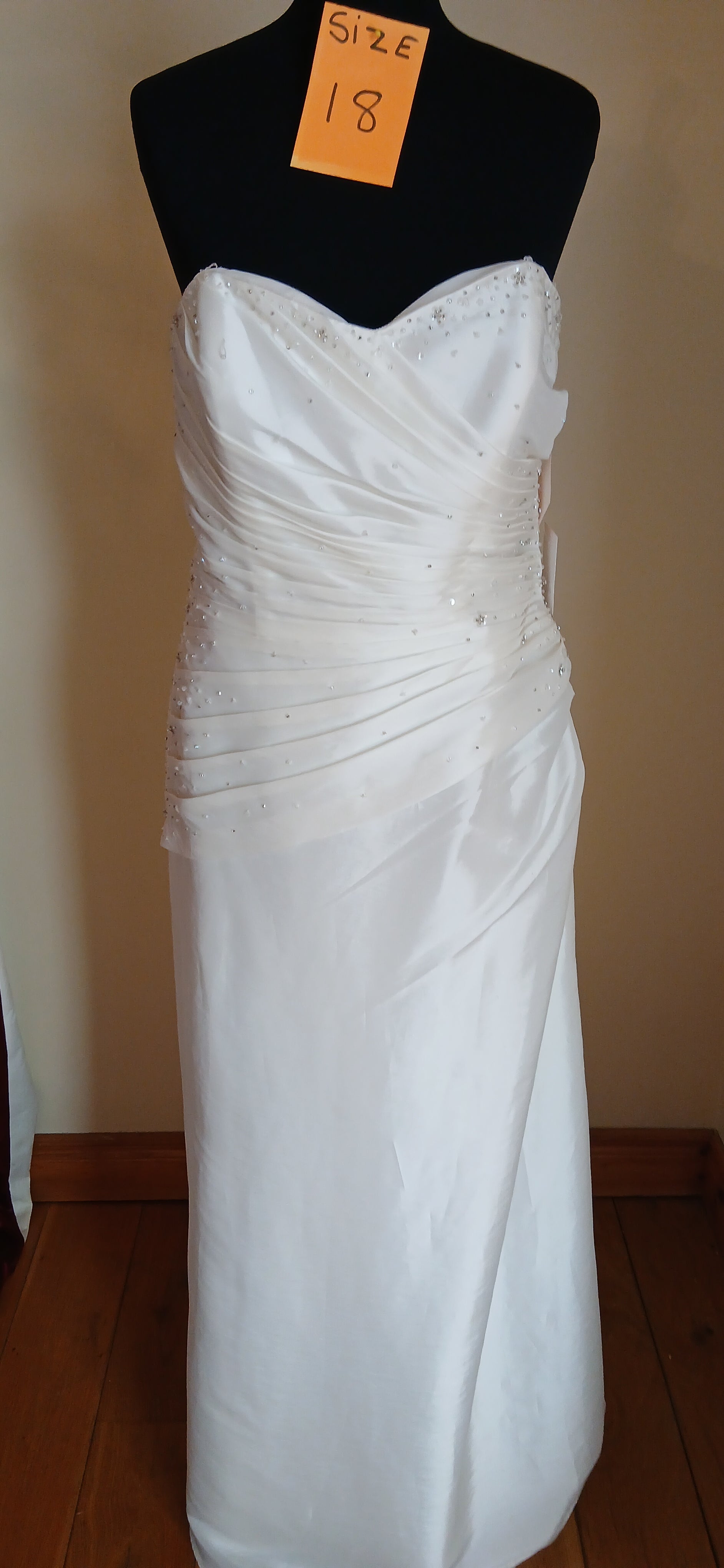 The dress is made from high-quality, ivory pleated fabric that gives it a timeless and elegant look.