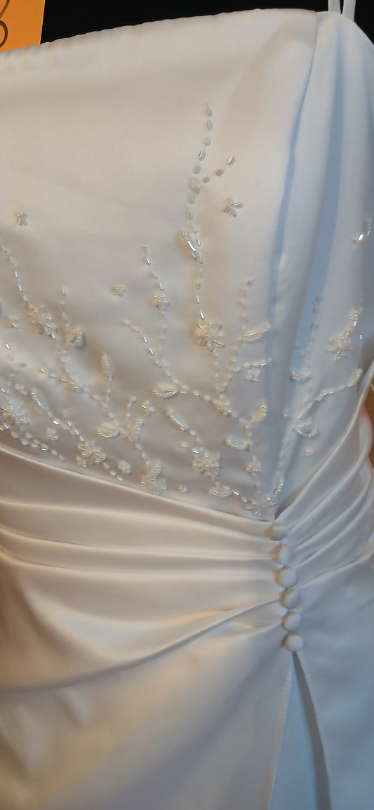 Close-up of a white wedding dress with intricate detailing