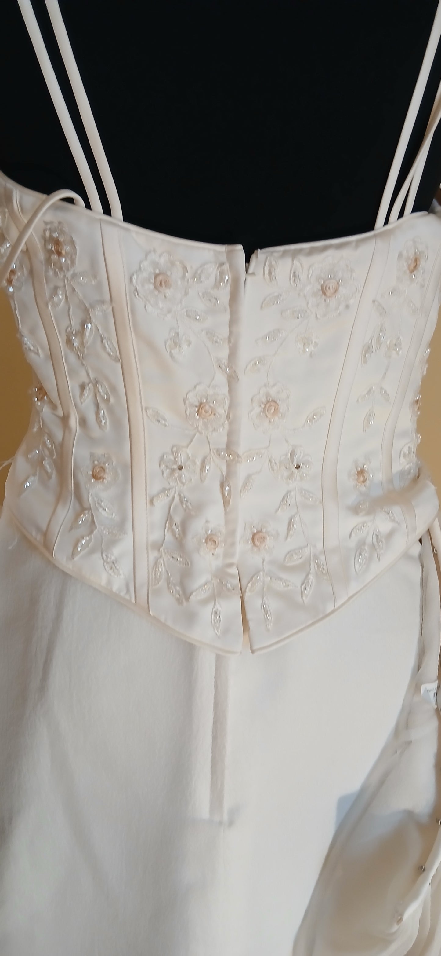 This exquisite wedding dress is a size 12 in elegant ivory.
