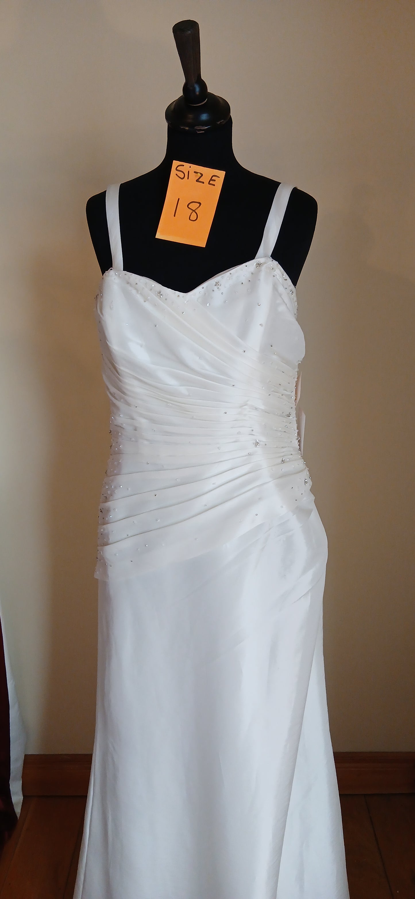 This exquisite wedding Dress Klara is a size 18, featuring a corset back design that accentuates the bride's figure