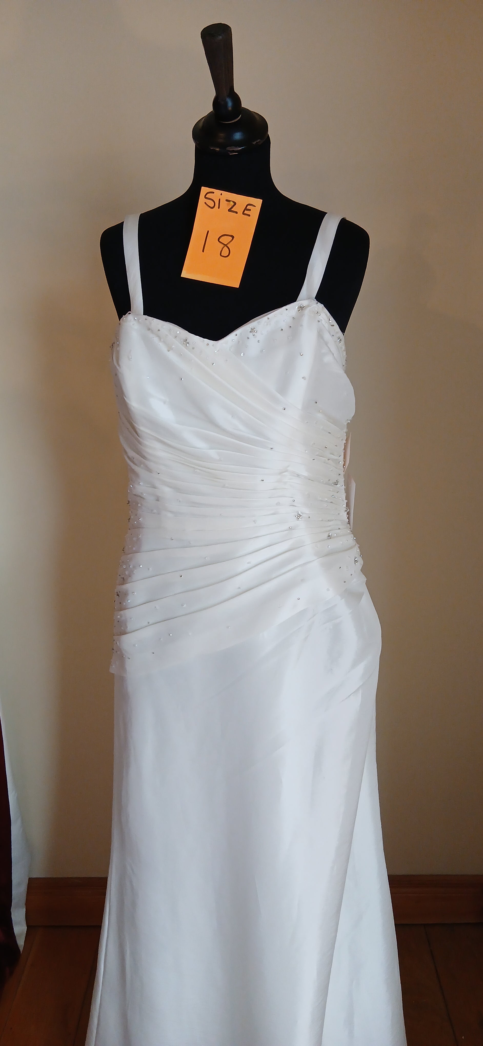 This exquisite wedding Dress Klara is a size 18, featuring a corset back design that accentuates the bride's figure