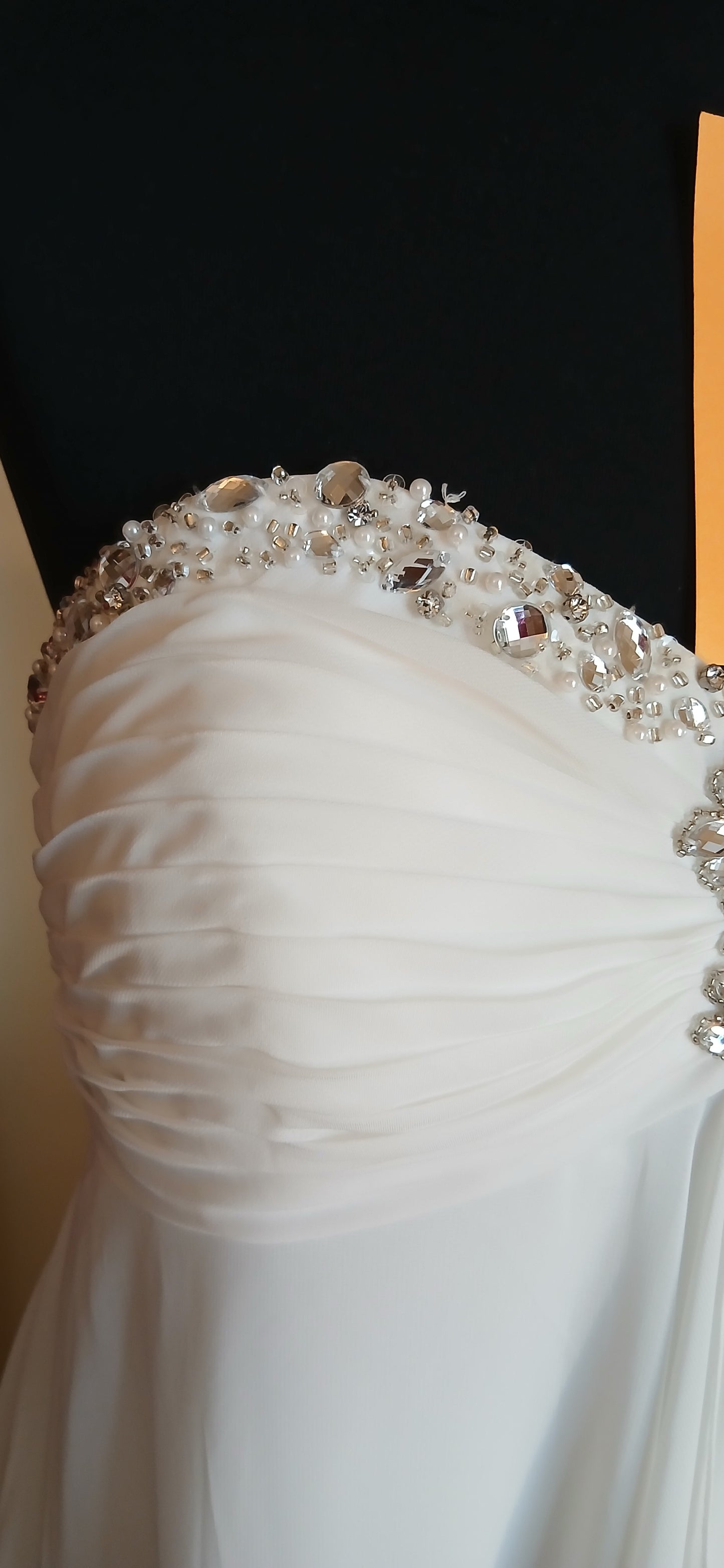 featuring a beautiful empire line design with a stunning beaded sweetheart neckline. 