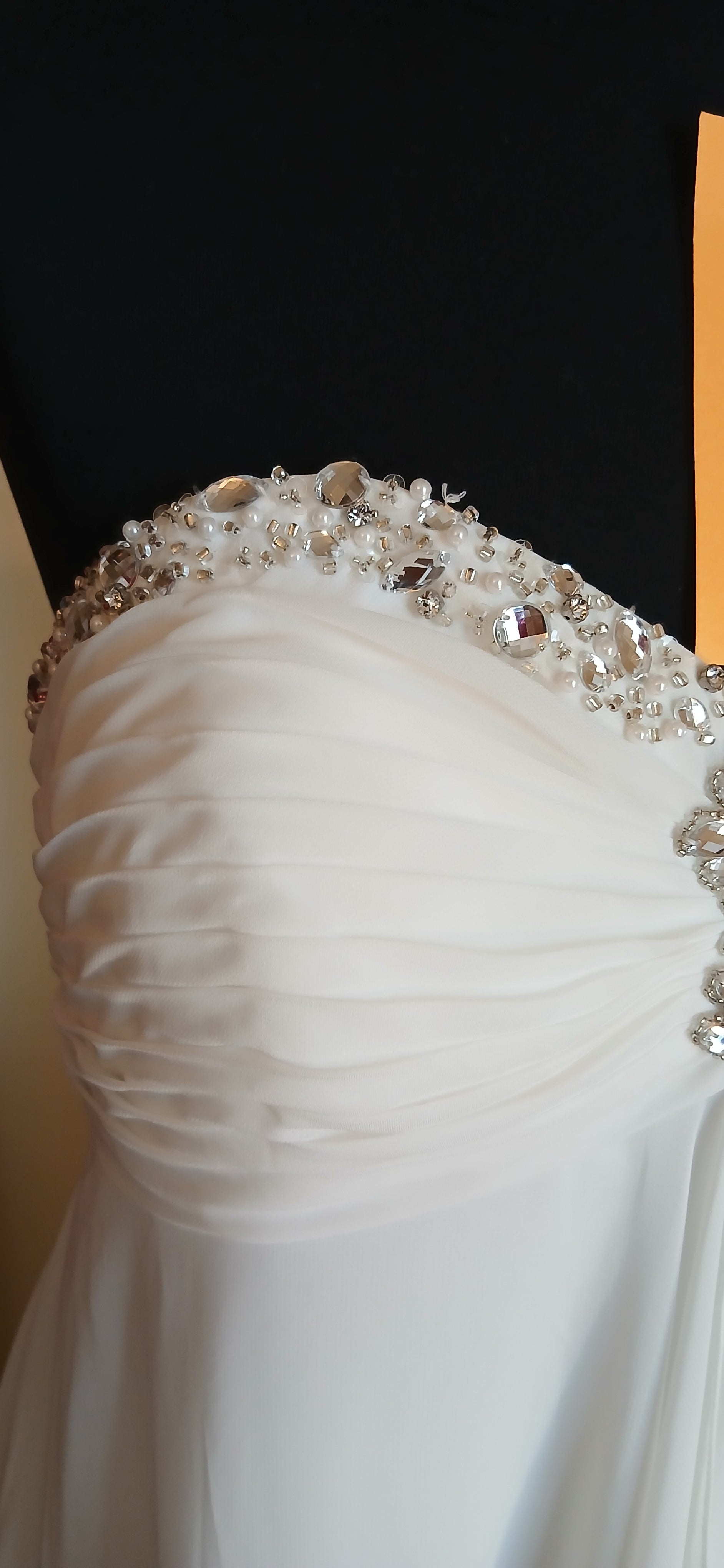 featuring a beautiful empire line design with a stunning beaded sweetheart neckline. 