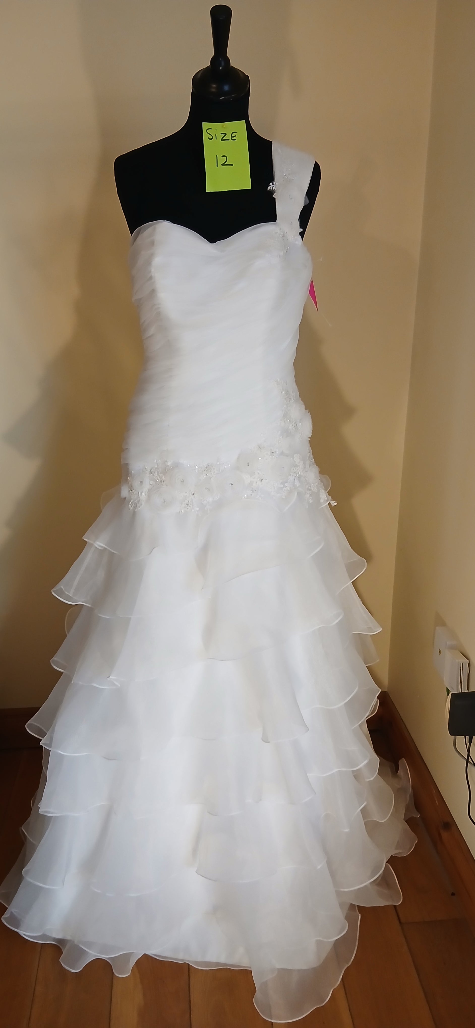 This exquisite Wedding dress Flamenco is a size 12 in ivory. It features a stunning one-strap design 